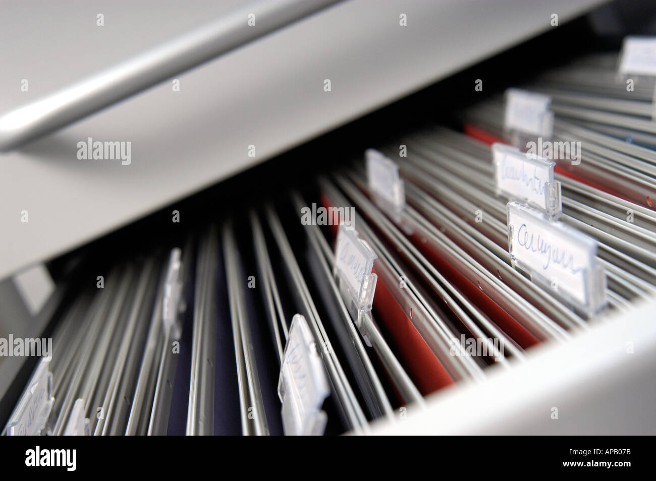 Old fashioned suspension files with title labels, hanging in a filing cabinet. Stock Photo