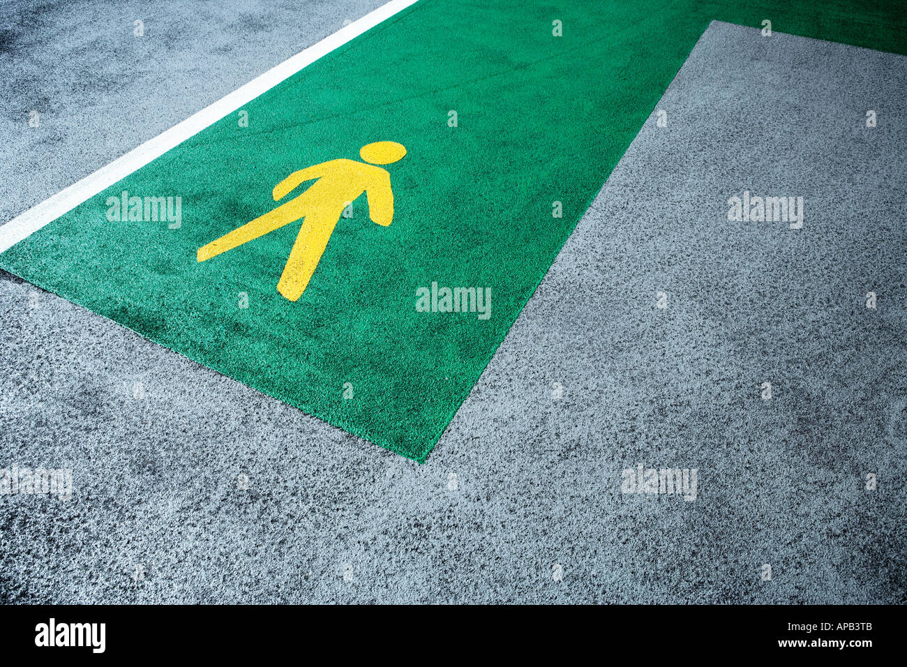 Yellow sign indicating directions, for pedestrians, in a car park Stock Photo