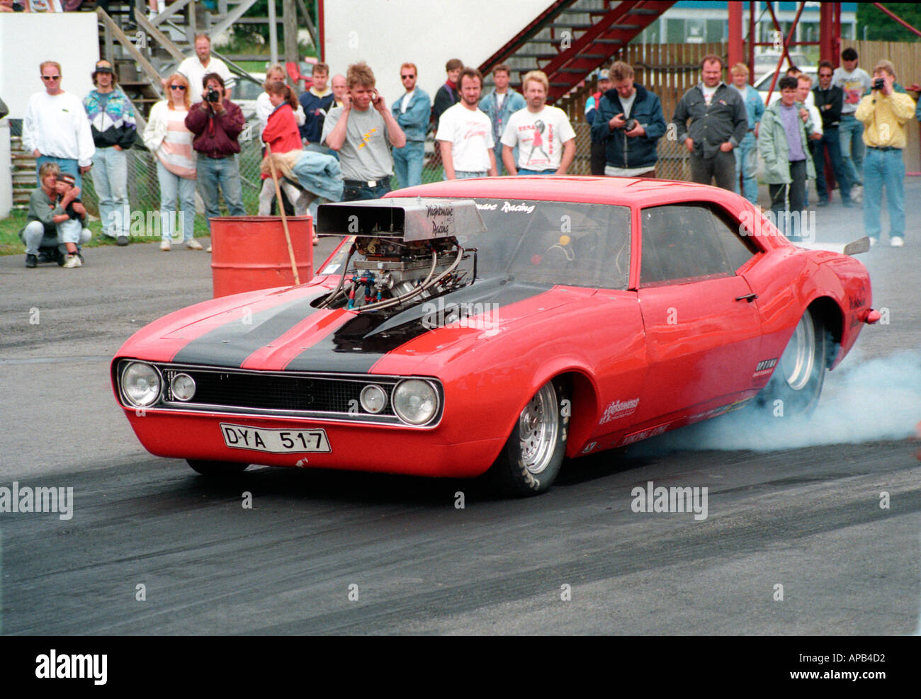 1969 chevrolet camaro streer leagal drag car burning out at mantrop park in sweden chevy burn burning rubber tyre smoke car shel Stock Photo