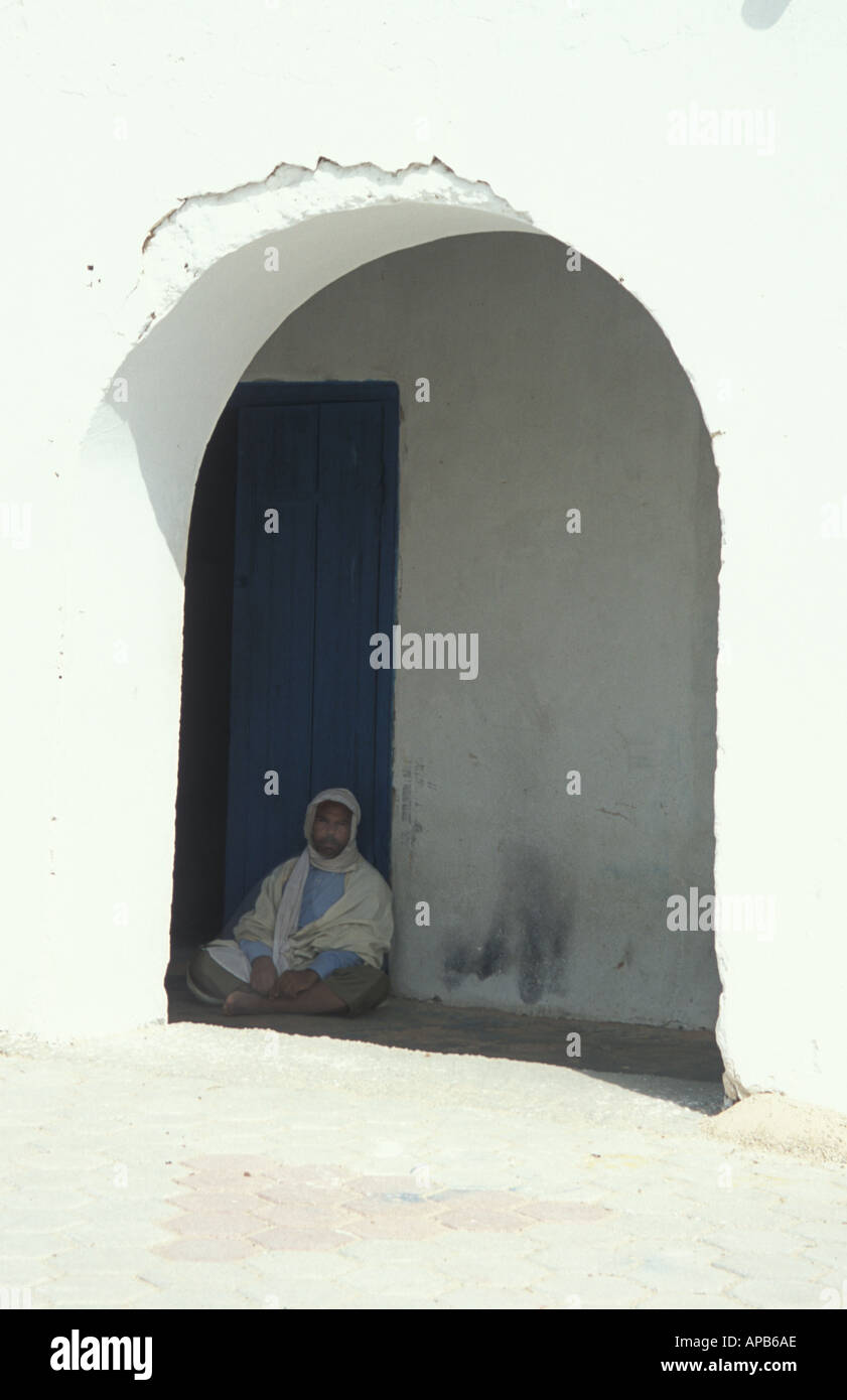 A man having a rest in  fhe shade Douz Tunisia Stock Photo