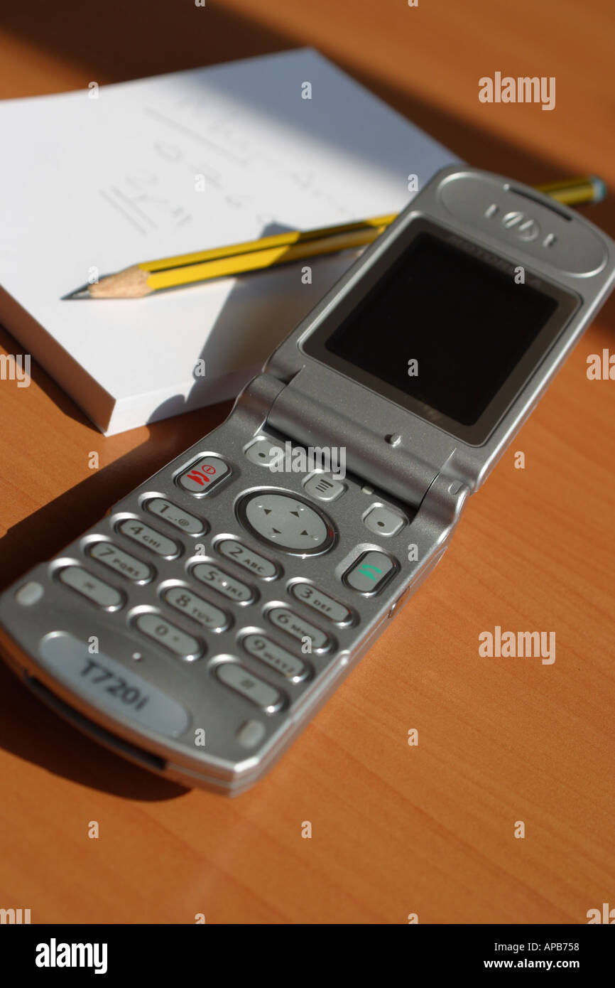 Motorola T720i mobile telephone with display screen notepad and pencil on an office desk taken 2004 Stock Photo