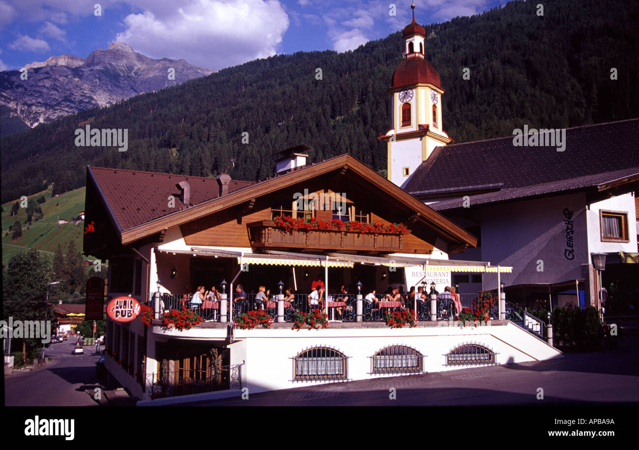 Terrace restaurant and church clock tower, Neustift im Stubaital, Stubai Alps, Tirol, Austria Stock Photo