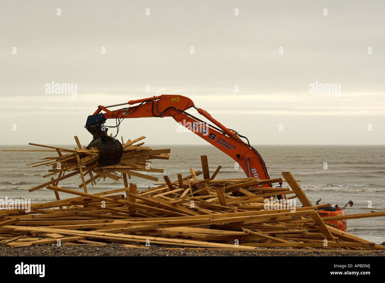 Salvage begins on timber washed up on Worthing beach, West Sussex. Stock Photo