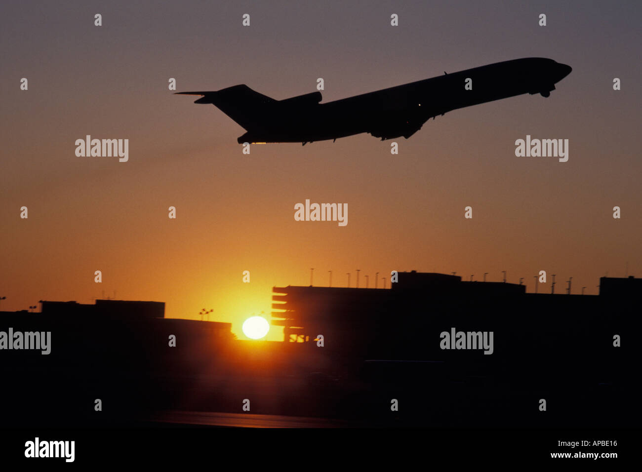 Silhouette of airplane against the sunset sky Stock Photo - Alamy