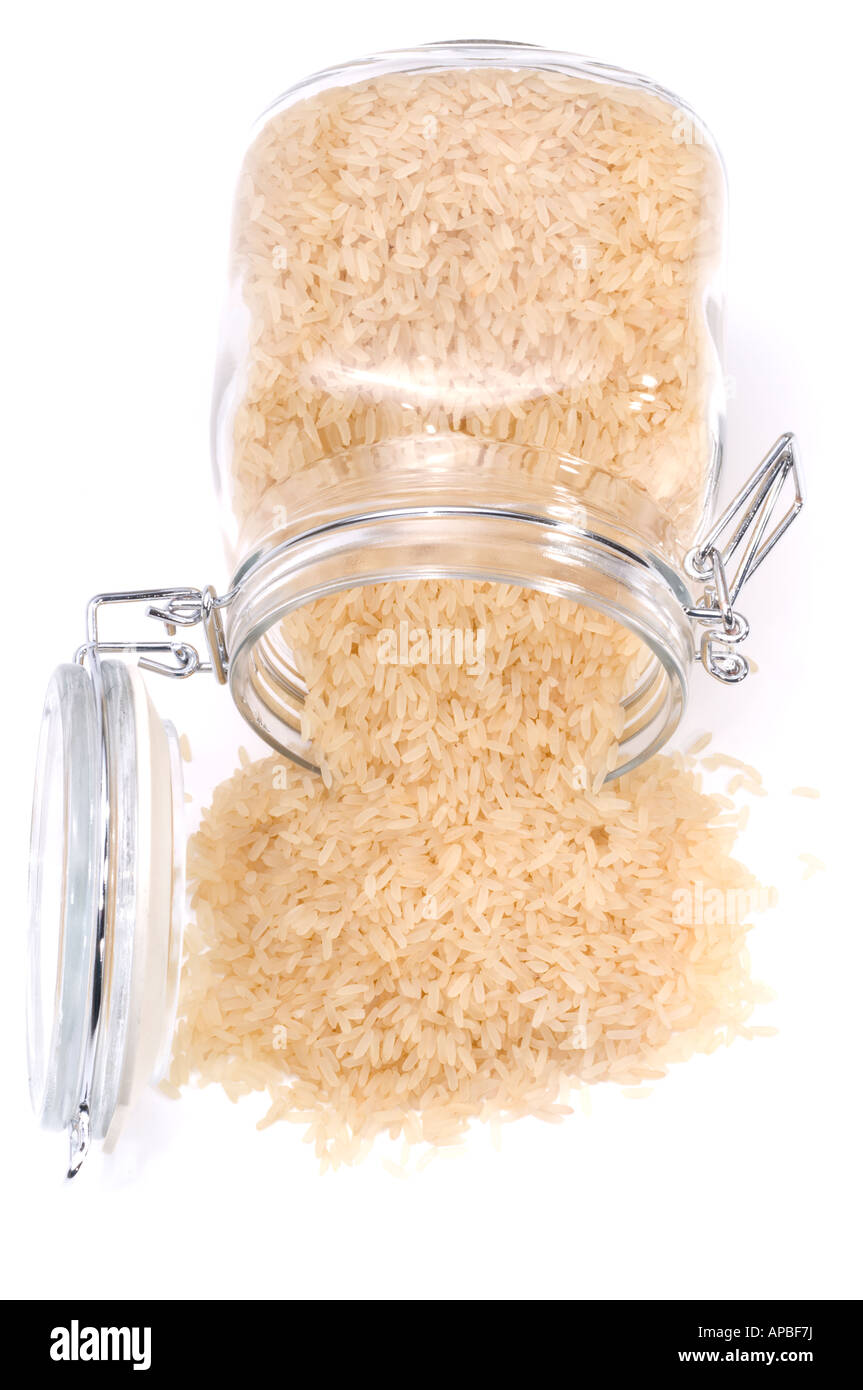 Rubber sealed glass container spilling long grain white rice Stock Photo