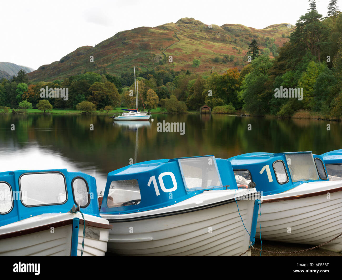 United Kingdom Cumbria Lake District National Park Ullswater Glenridding row of boats for rent at Ullswater Stock Photo
