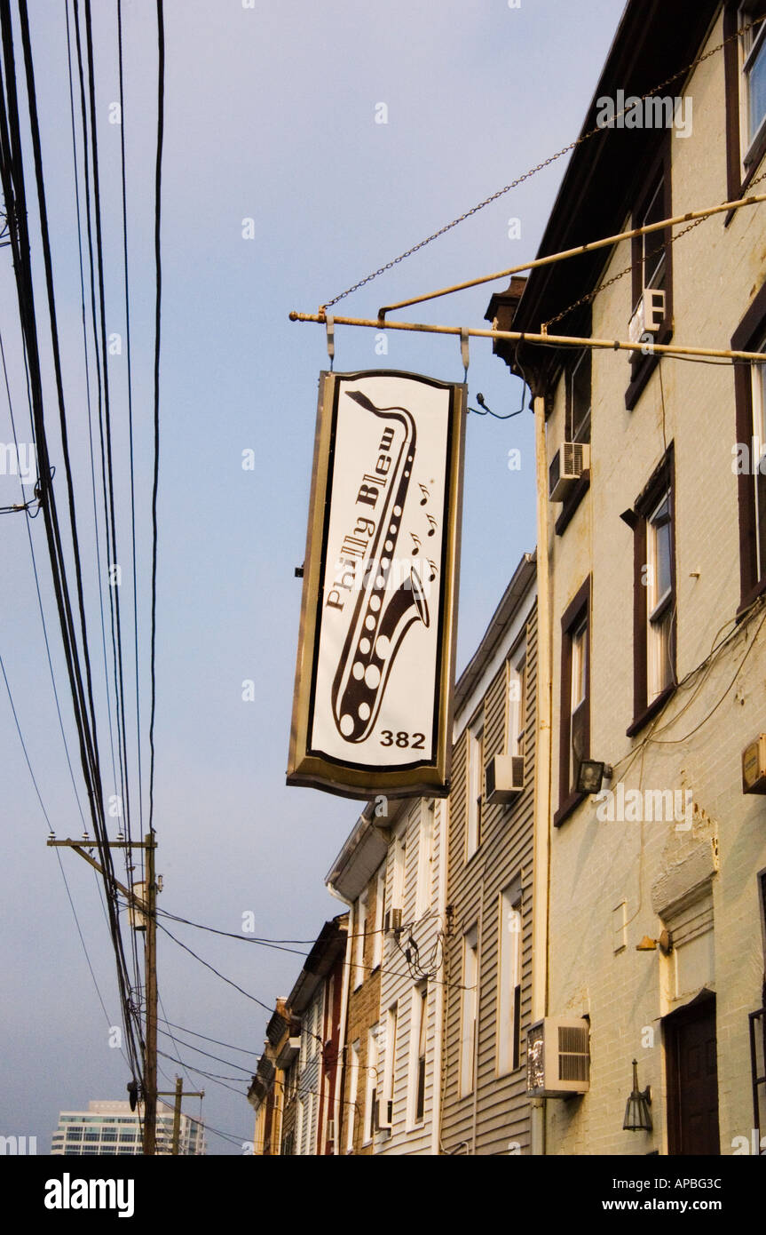 sign for the Philly Blew Jazz Club in tenement buildings in Conshohocken Pennsylvania near Philadelphia with electric wires near Stock Photo