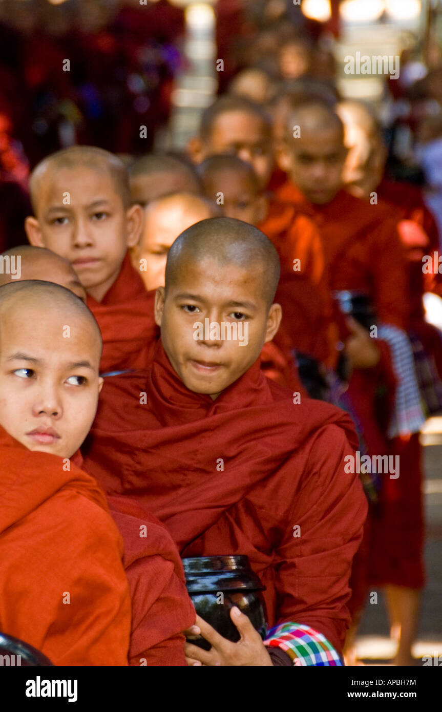 Novice monk in line for lunch at Maha Gandhayon Kyaung Monastery in Amarapura Burma Stock Photo