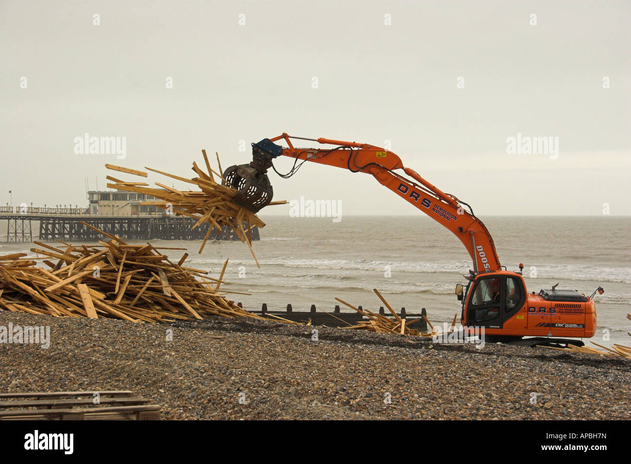 Salvage begins on timber washed up on Worthing beach, West Sussex. Stock Photo