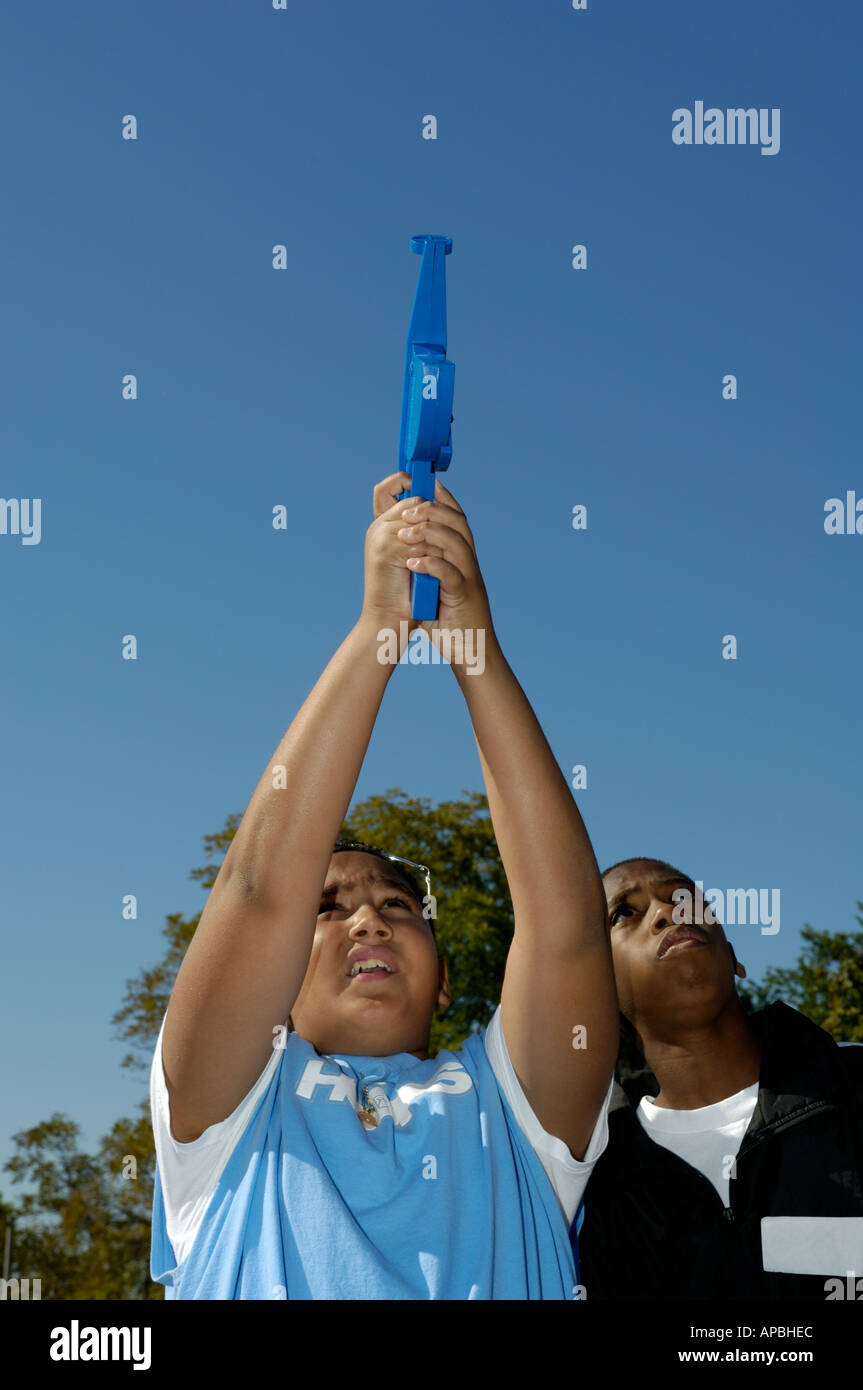 Science student using a model rocket altitude tracking device Stock