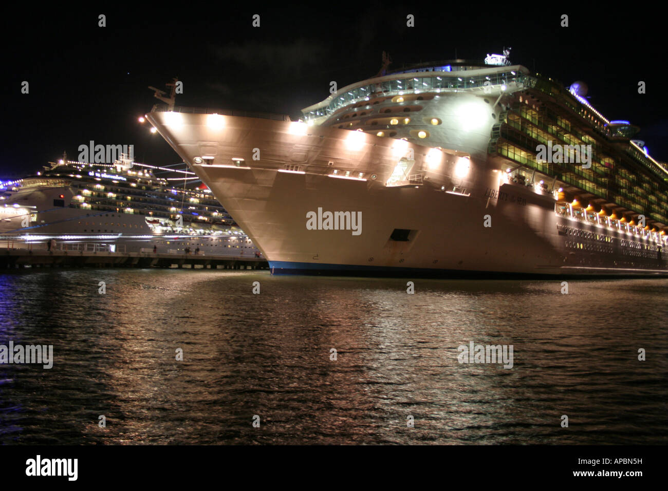Cruise ship docked in port at night Stock Photo