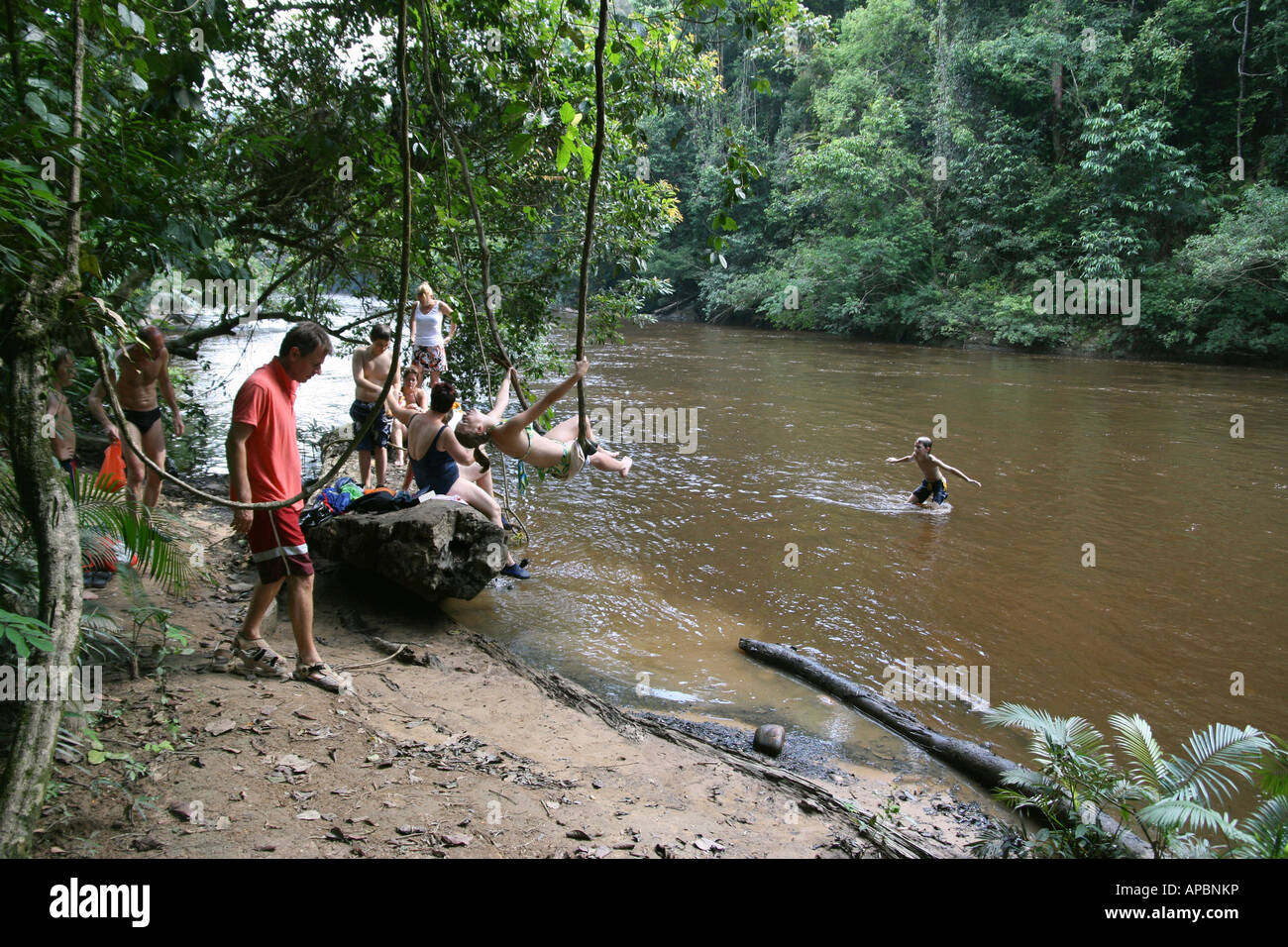 Tourists enjoy Lubok Simpon swimming spot on Tahan river Taman Negara Malaysia Stock Photo