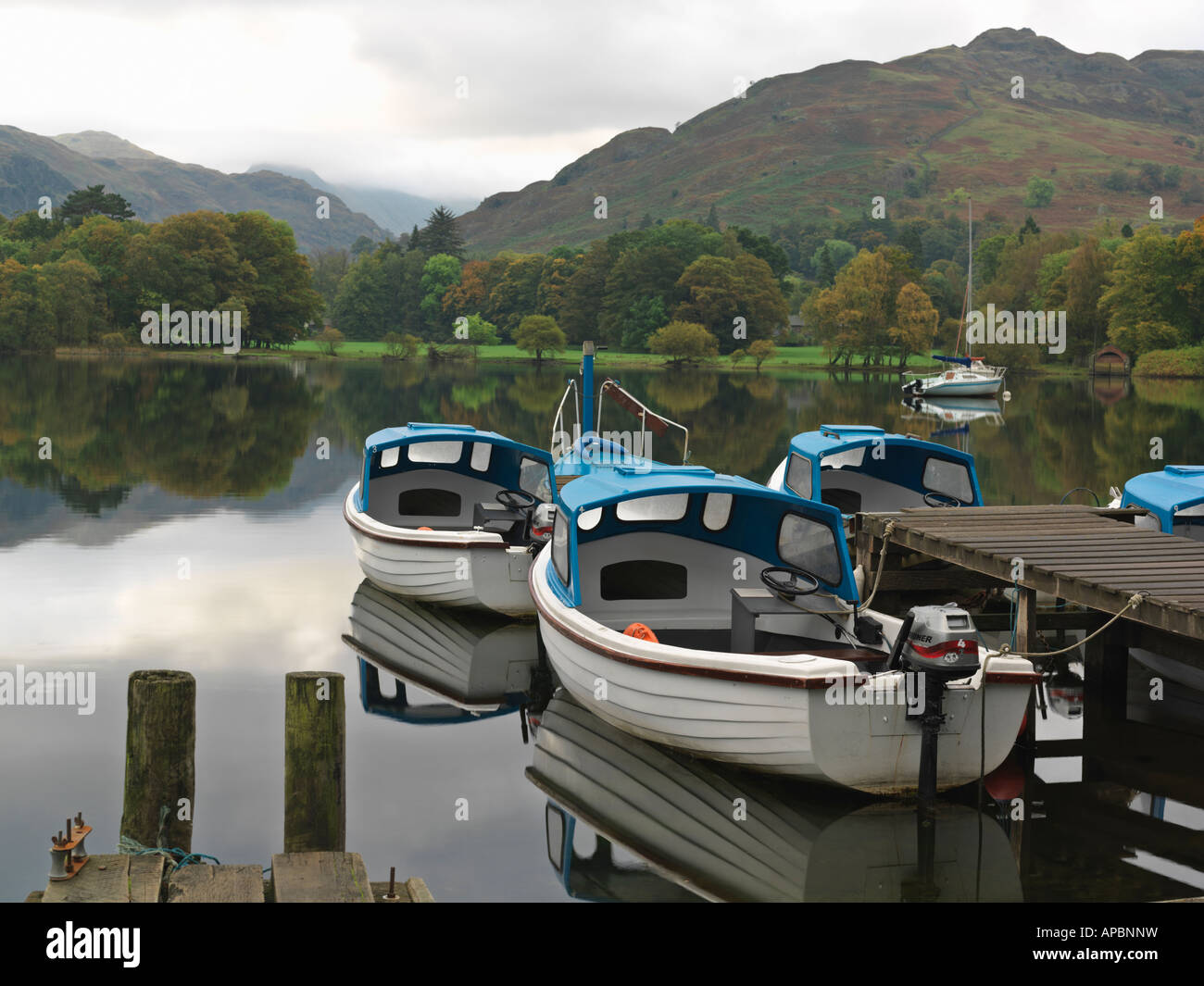 United Kingdom Cumbria Lake District National Park Ullswater Glenridding boats moored at dock for rent at Ullswater Stock Photo