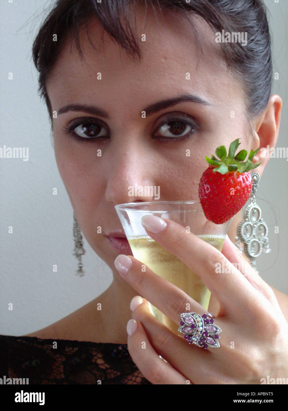 Portrait of an Elegant Woman Holding a Champagne Glass Stock Photo