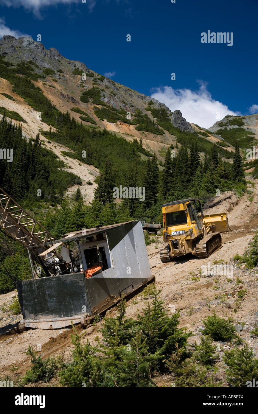 Bulldozer moving diamond drilling rig Astlais mountain BC Stock Photo