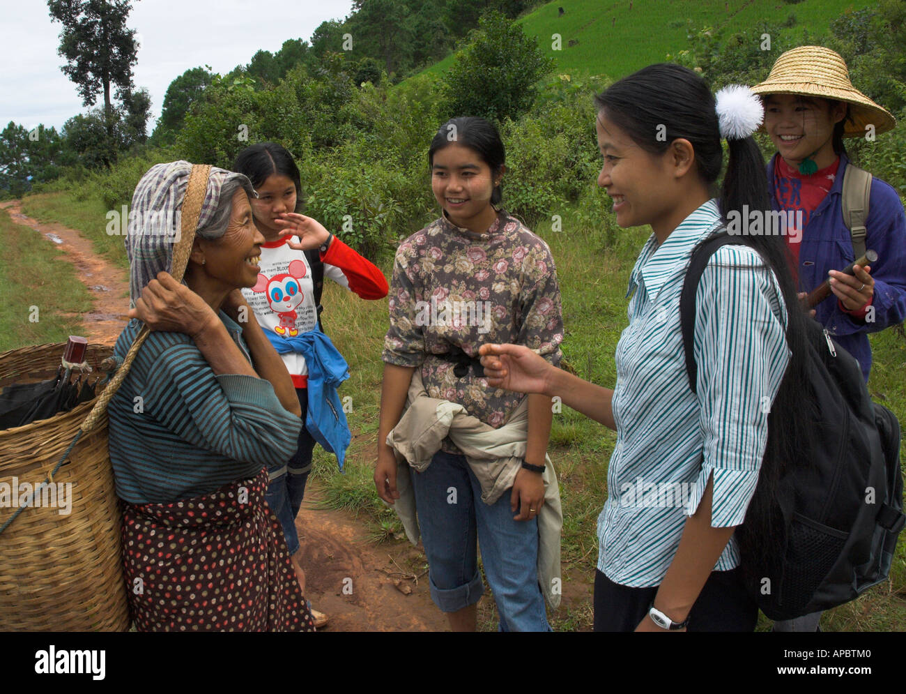 Myanmar Burma Shan State Burma In the hills near Lyupin Advocacy female staff from local NGO talking to elderly female peasant Stock Photo