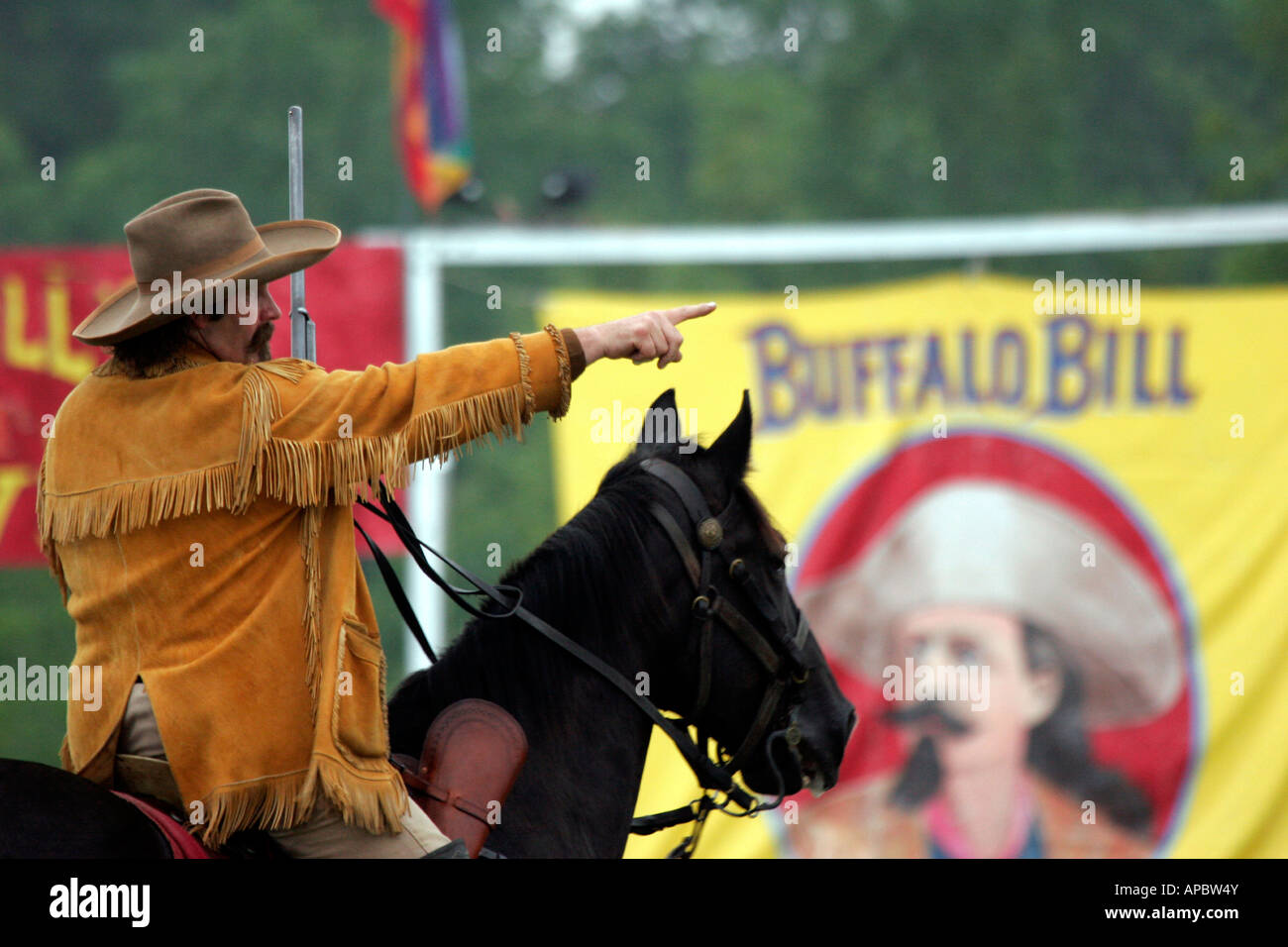 Buffalo Bill pointing at a target that he will be shooting at during a Wild West Reenactment Show Stock Photo