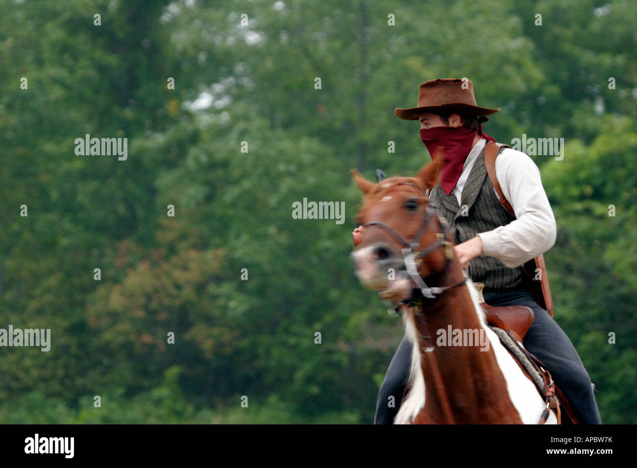 A cowboy bandit on horseback getting ready for a shootout Stock Photo