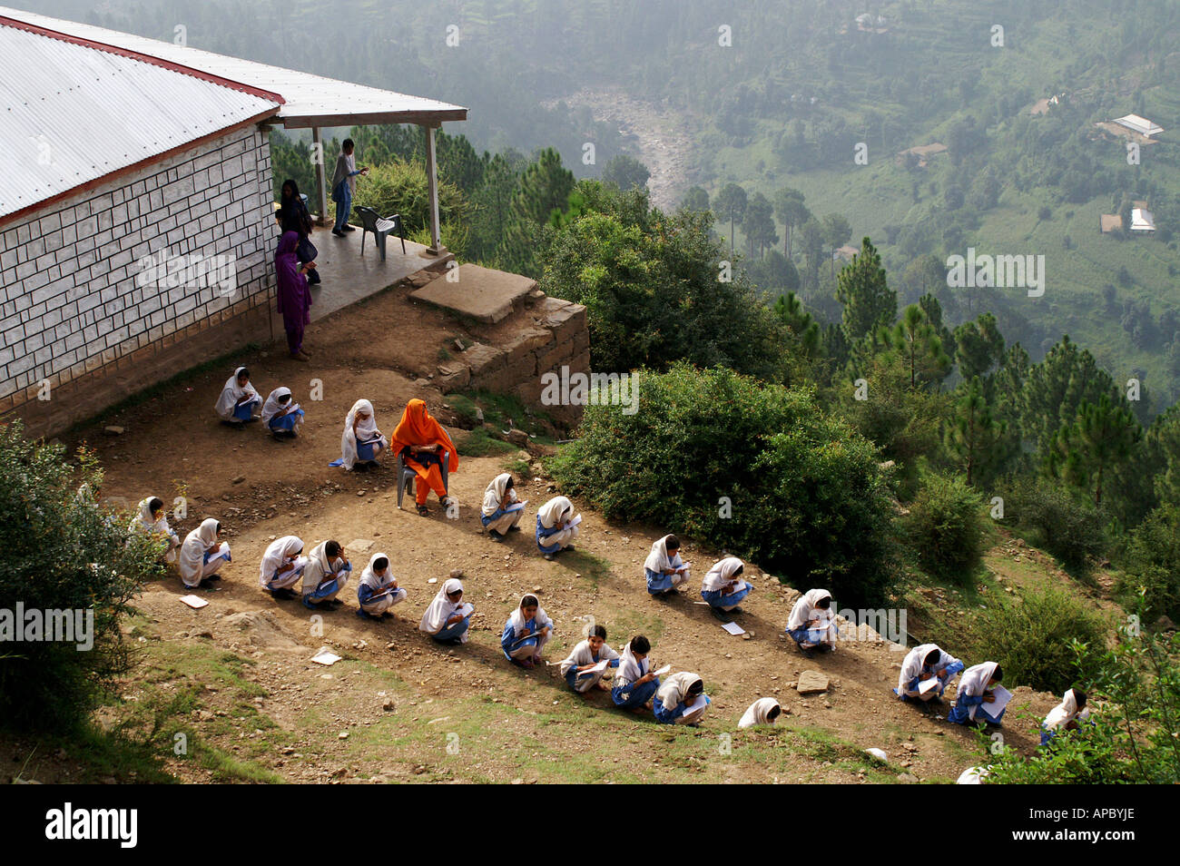 As the classroom was destroyed by the earthquake, the examination takes place outside, Hajira, AJK Kashmir, Pakistan Stock Photo