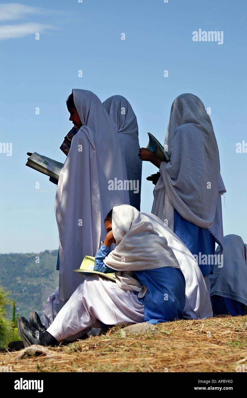 Students of a Girls Higschool near Bagh, AJK Kashmir, Pakistan. Since their old school was destroyed, the lessons take place Stock Photo