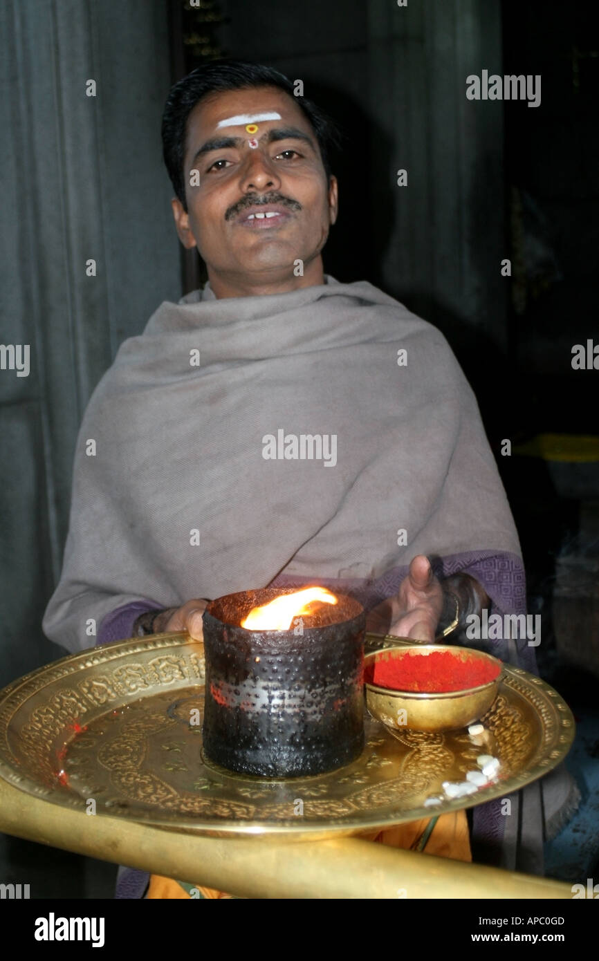 Hindu Priest offers arti or fire pooja and sindur power, India Stock Photo