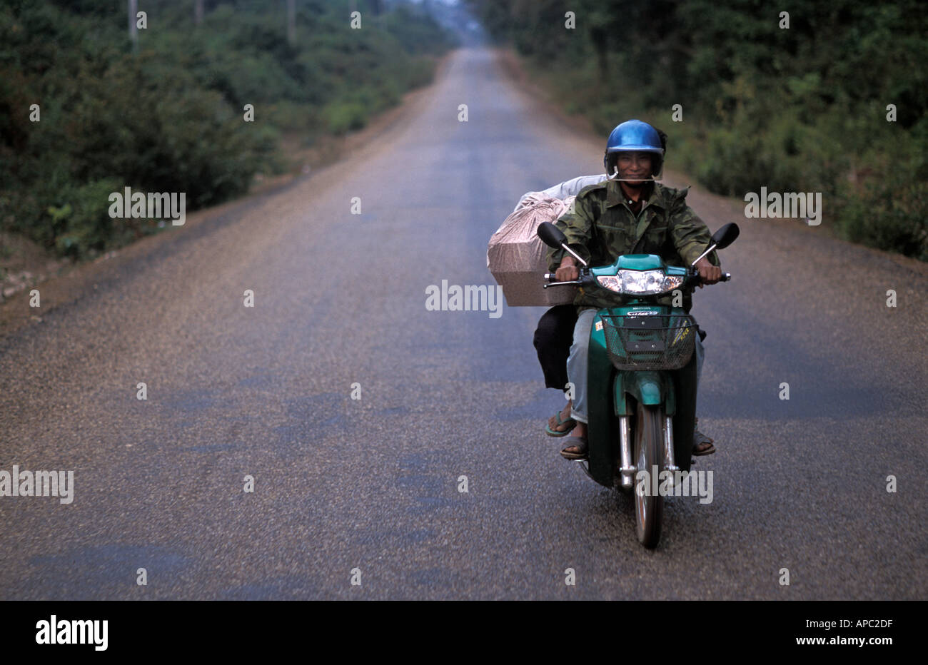 Being followed by a motorcycle whilst travelling in a songthaew to the Cambodian border S Laos Stock Photo