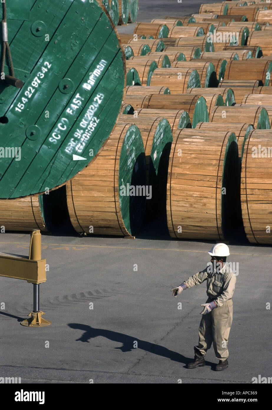 Worker directing crane operator at electric company Saudi Arabia Stock