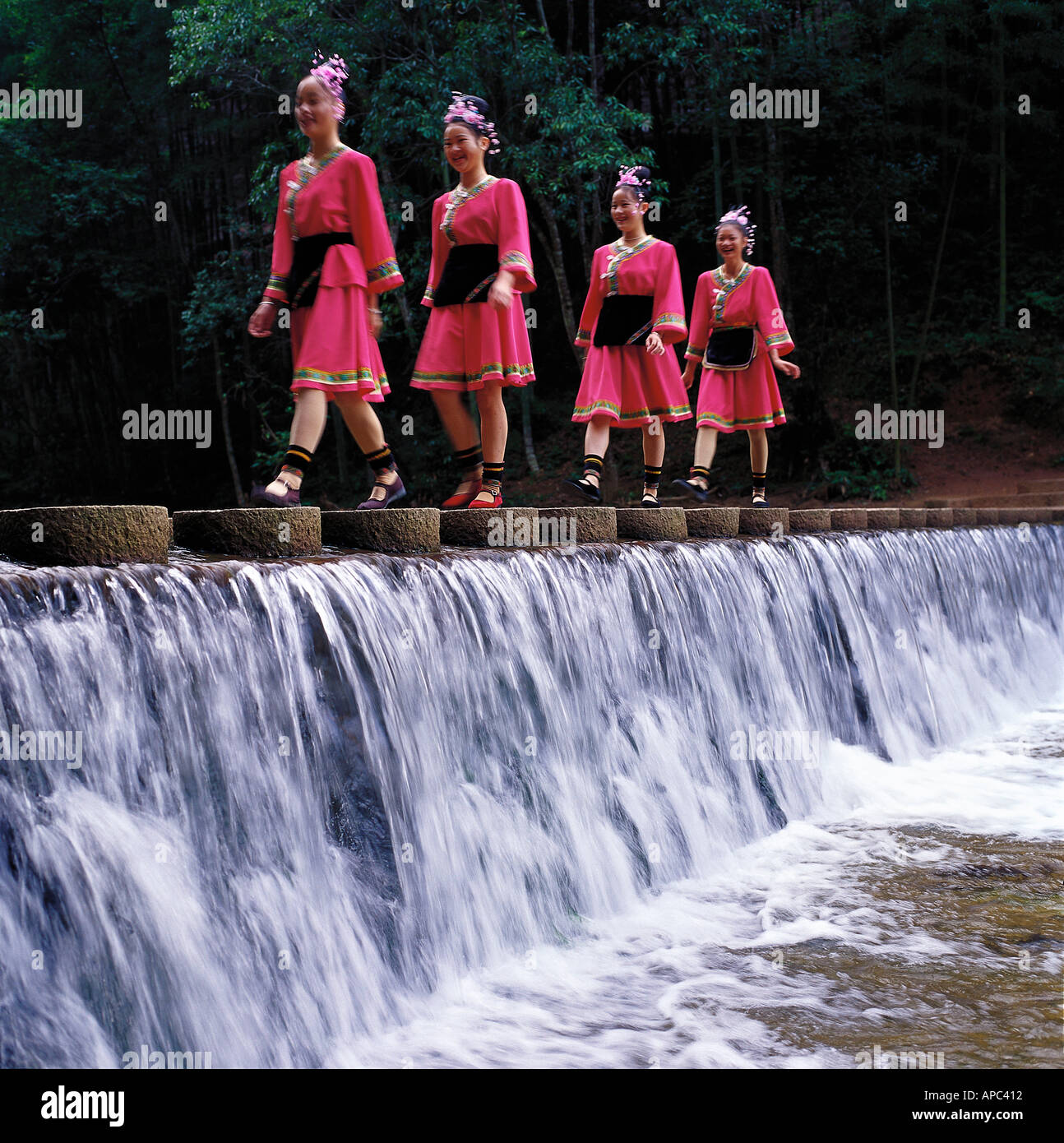 Four women in traditional costumes performing on water Stock Photo - Alamy
