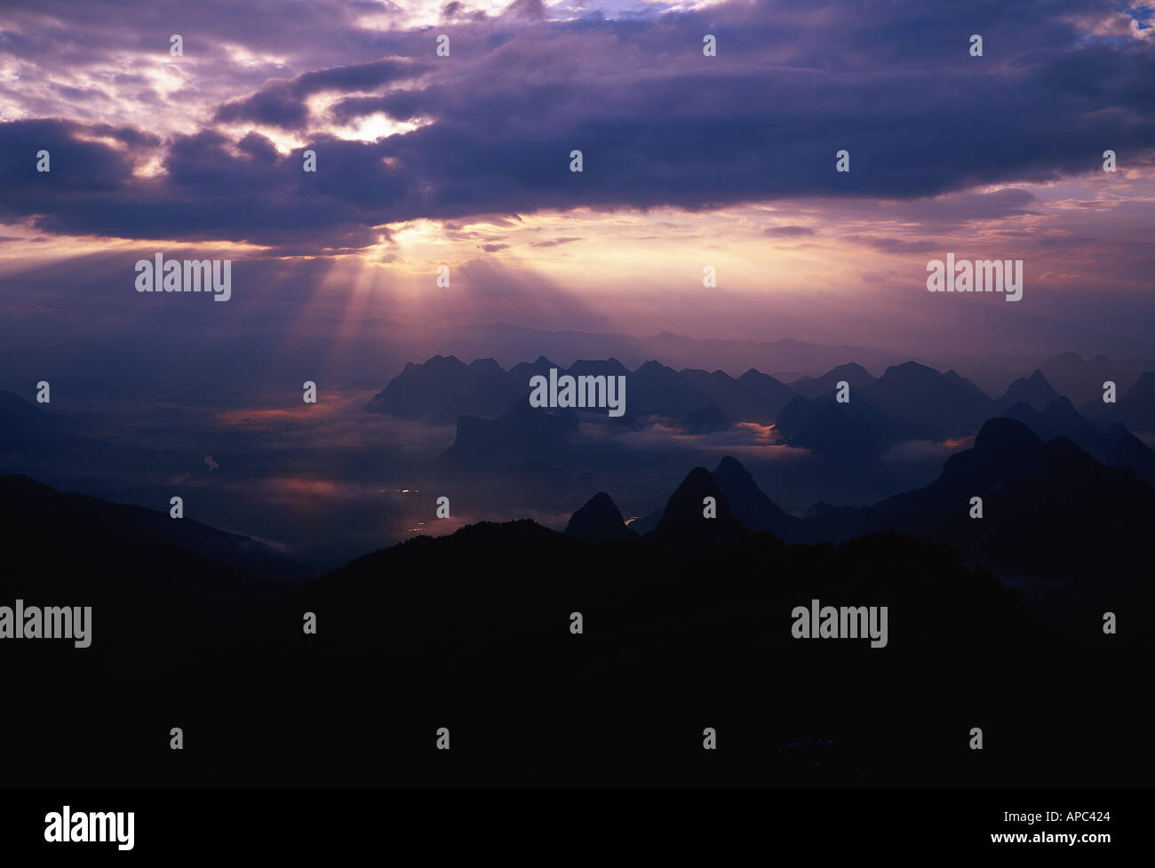 sun rising over hills Stock Photo Alamy