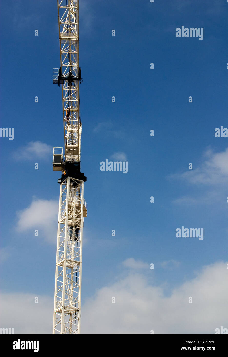 Construction Crane Against Cloudy Sky in a commercial district of a ...