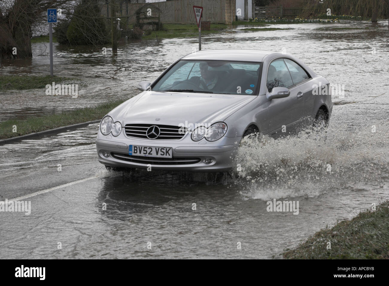 A car negotiates flooded cross roads after heavy rain south of