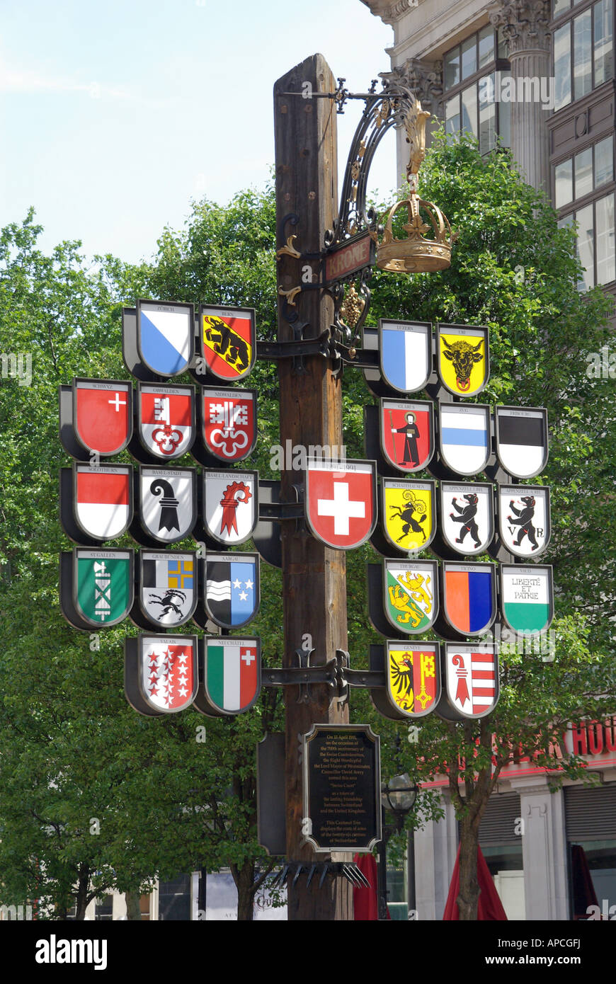 London Leicester Square display coats of arms of Swiss cantons mounted on a pole close to Switzerland tourist information centre Stock Photo