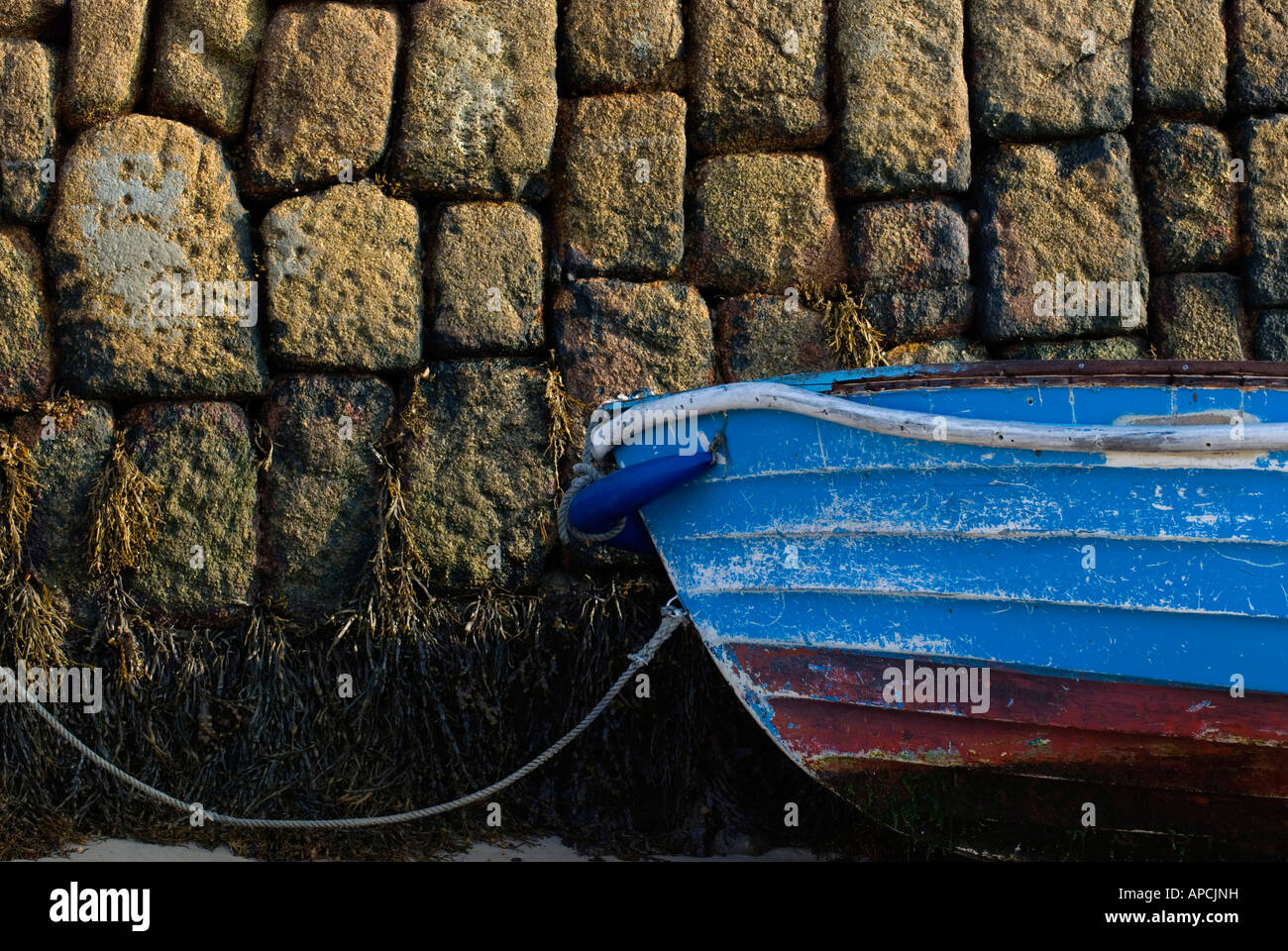 Boat moored against harbour wall St Marys Isles of Scilly England UK Stock Photo