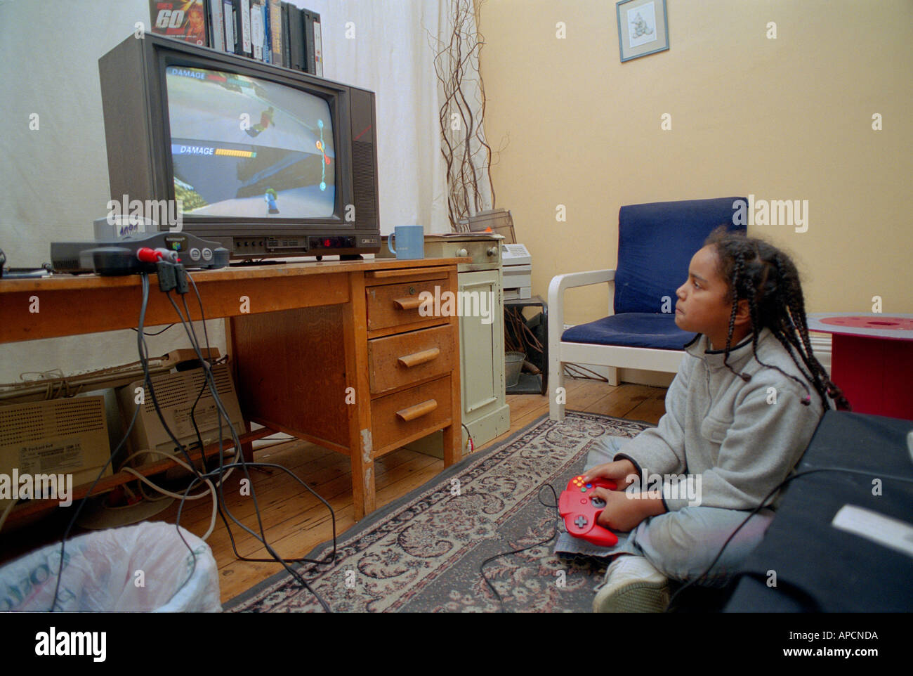 Young children playing on playstation at home. Stock Photo