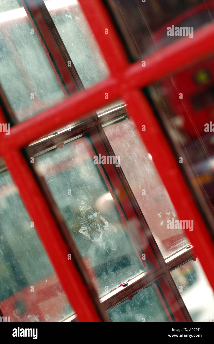 old fashioned telephone kiosk in red with windows and glass panels london england uk Stock Photo