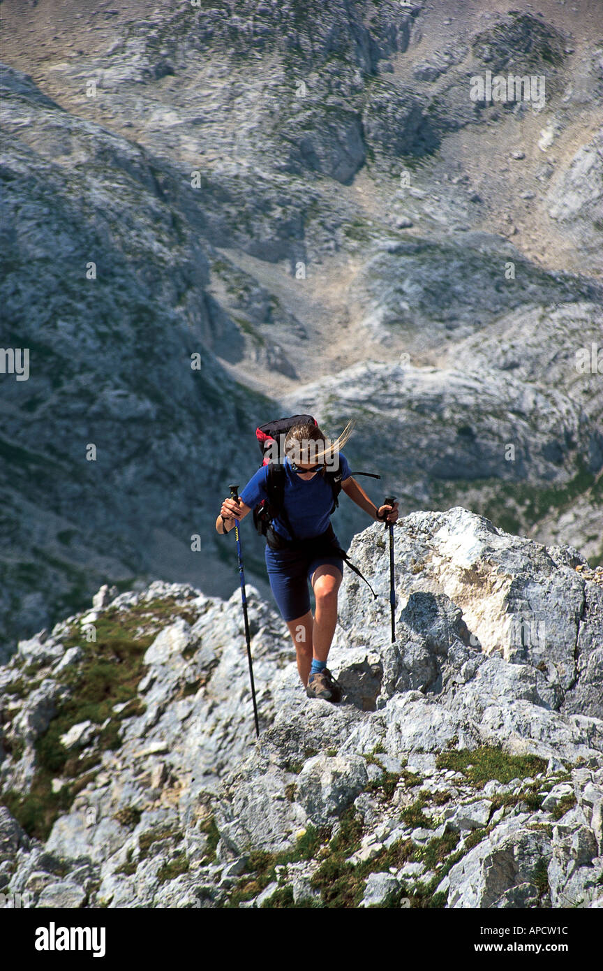 A female mountaineer on the pathless terrain of Julian Alps, Slovenia. Stock Photo