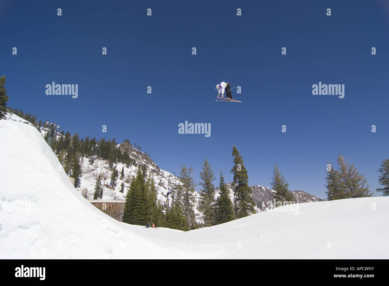 A skier jumping off a huge jump at Alpine Meadows in California Stock Photo