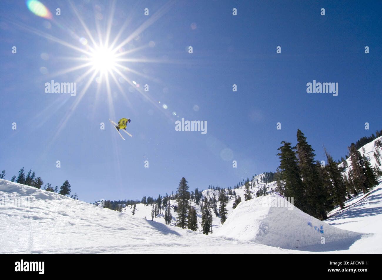 A skier jumping off a huge jump at Alpine Meadows in California Stock Photo