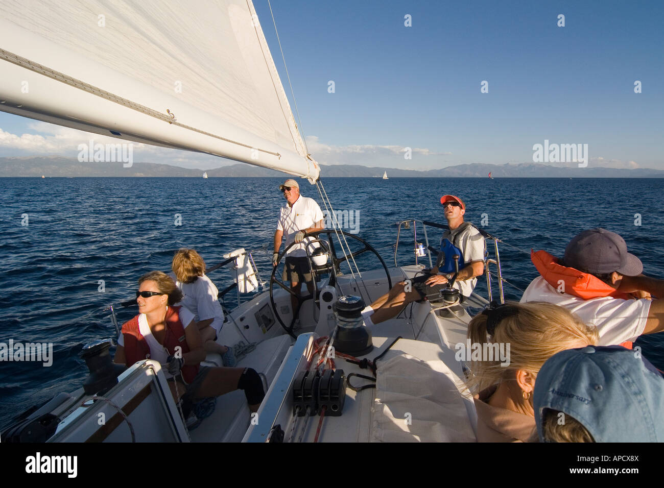 A crew on a sailboat during a race on Lake Tahoe in California Stock Photo