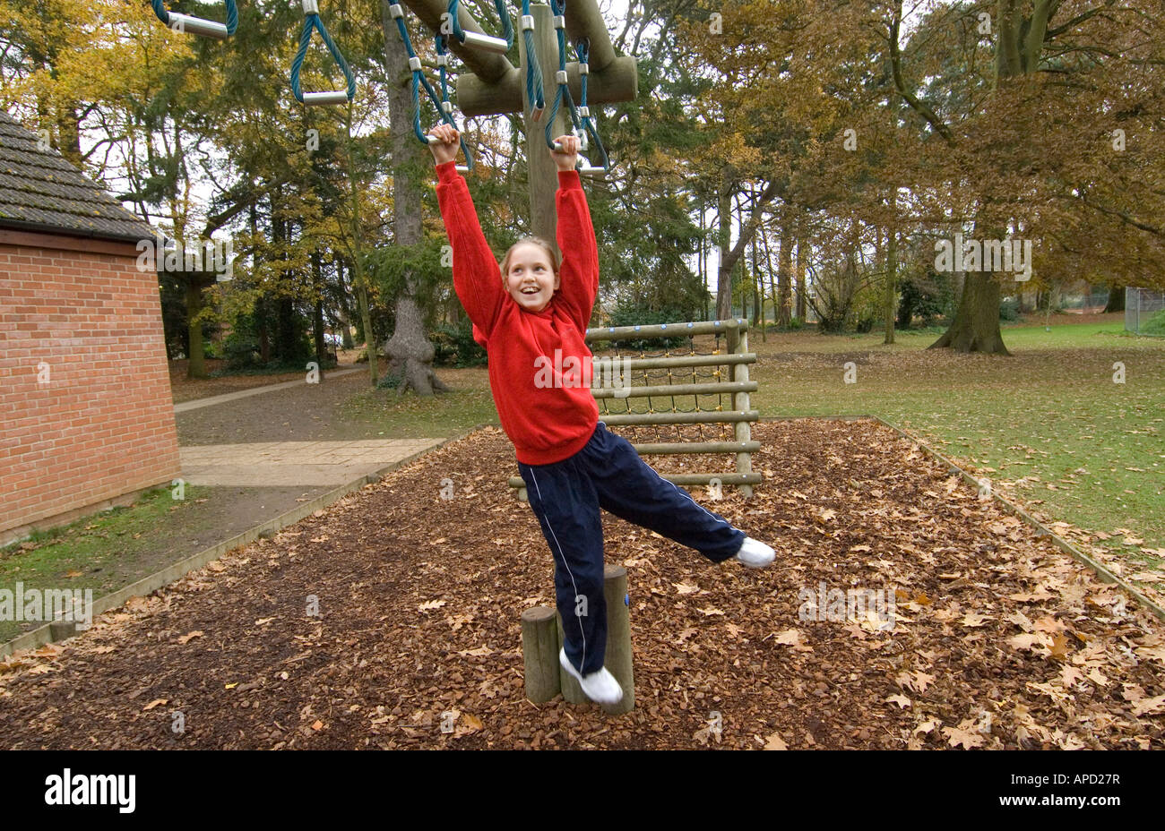 A child on the monkey bars gets some exercise and swings from grip to