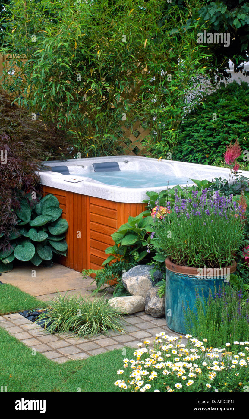 Outdoor jacuzzi in secluded area of garden Stock Photo Alamy