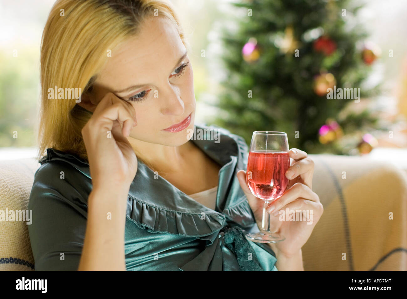 Woman alone at Christmas with glass of wine Stock Photo Alamy