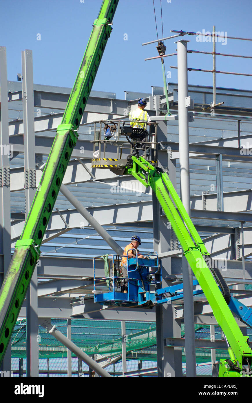Steel erectors on cherry pickers access platforms during installation