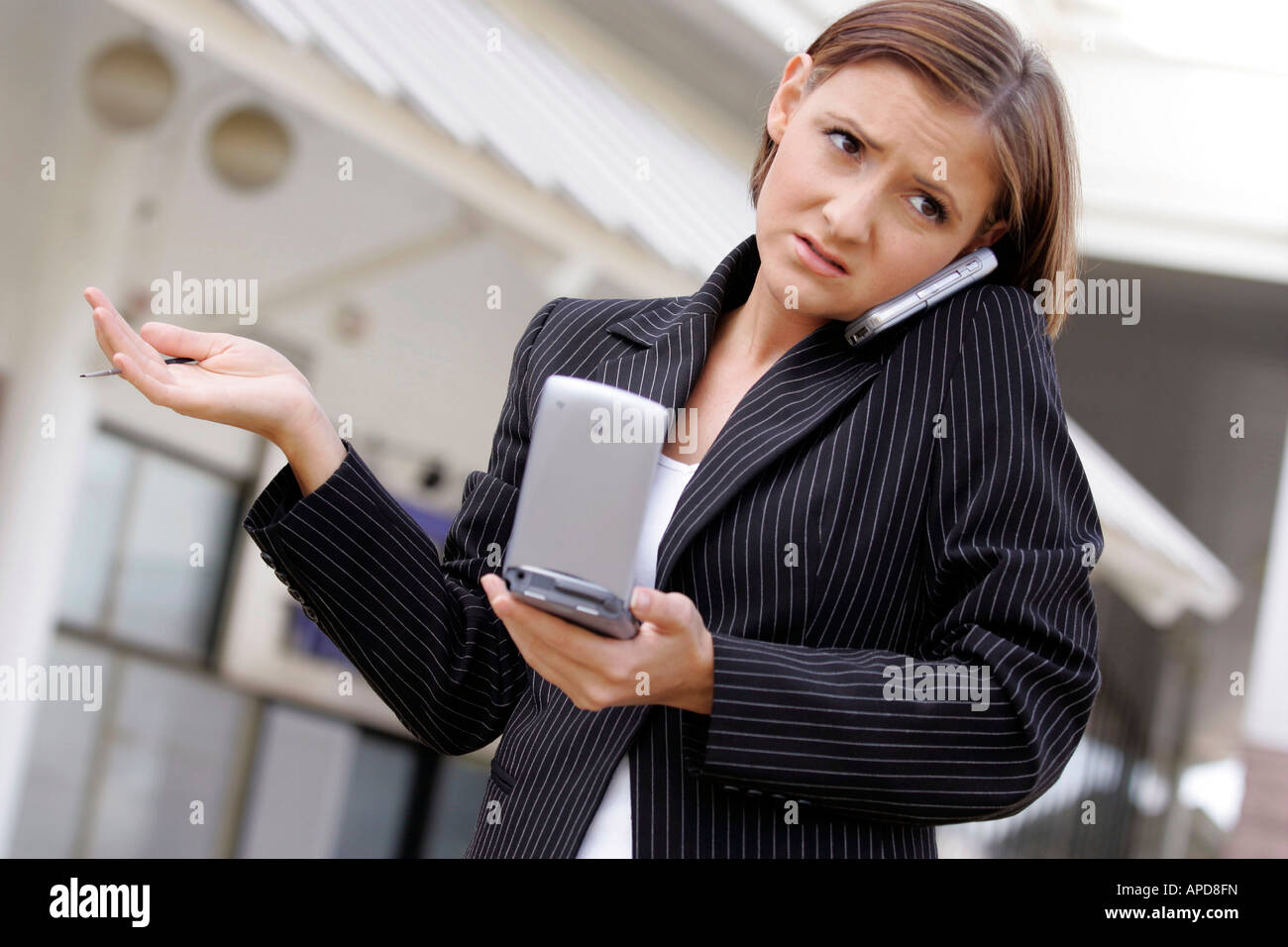 woman with personal organiser and mobile phone Stock Photo