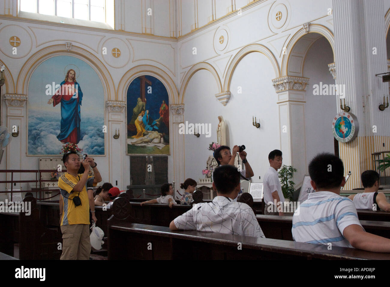 Chinese tourists photograph the interior of St Michael s catholic church built by the Germans in 1934 Qingdao Shandong China Stock Photo