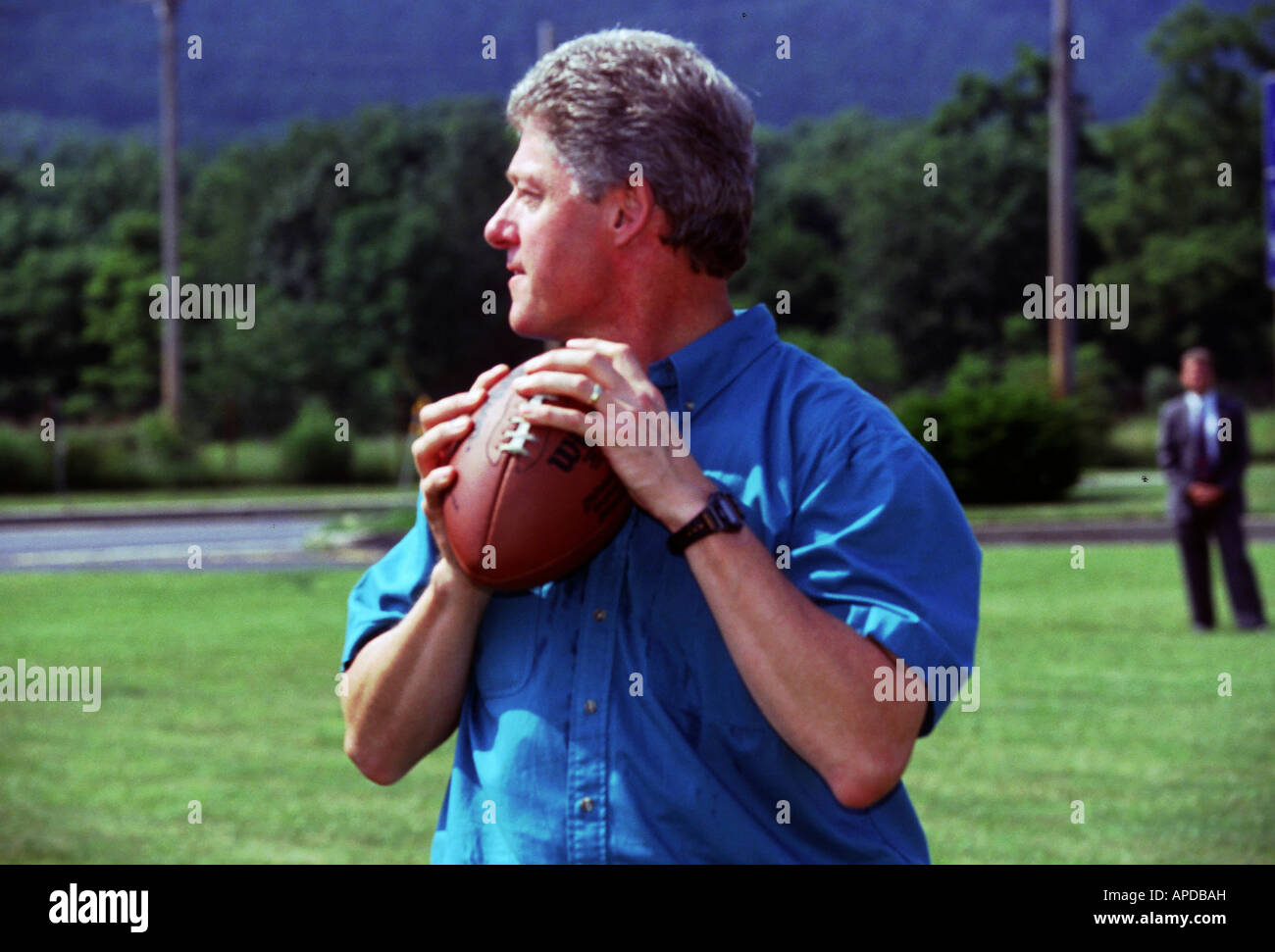 Presidential candidate Bill Clinton passes a football during a bus stop in Pennsylvania in August of 1996. Stock Photo