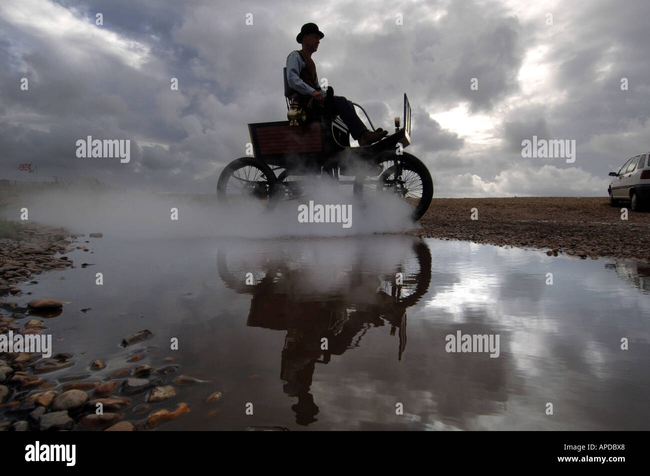 Engineer Martin Nutter drives his perfect replica of a 1902 Stanley Locomobile Spindleseat runabout steamcar through Normans Bay Stock Photo