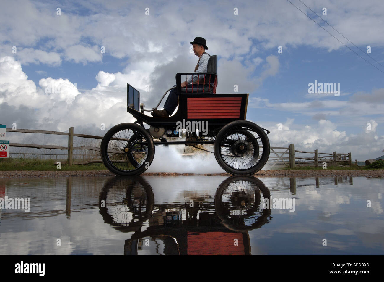 Engineer Martin Nutter drives his perfect replica of a 1902 Stanley Locomobile Spindleseat runabout steamcar through Normans Bay Stock Photo