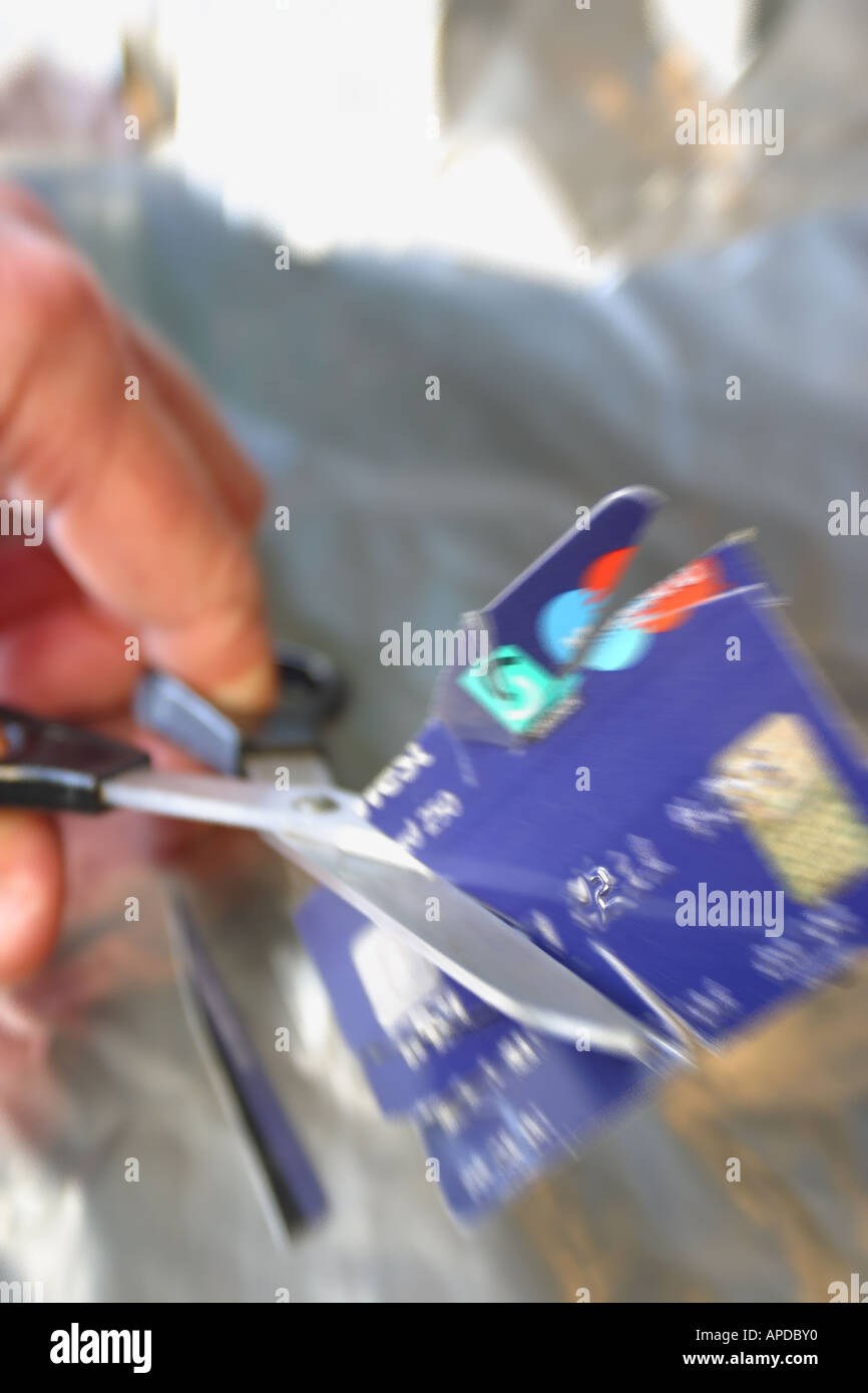 Cutting up a credit card with scissors zoom blur motion effect Stock Photo