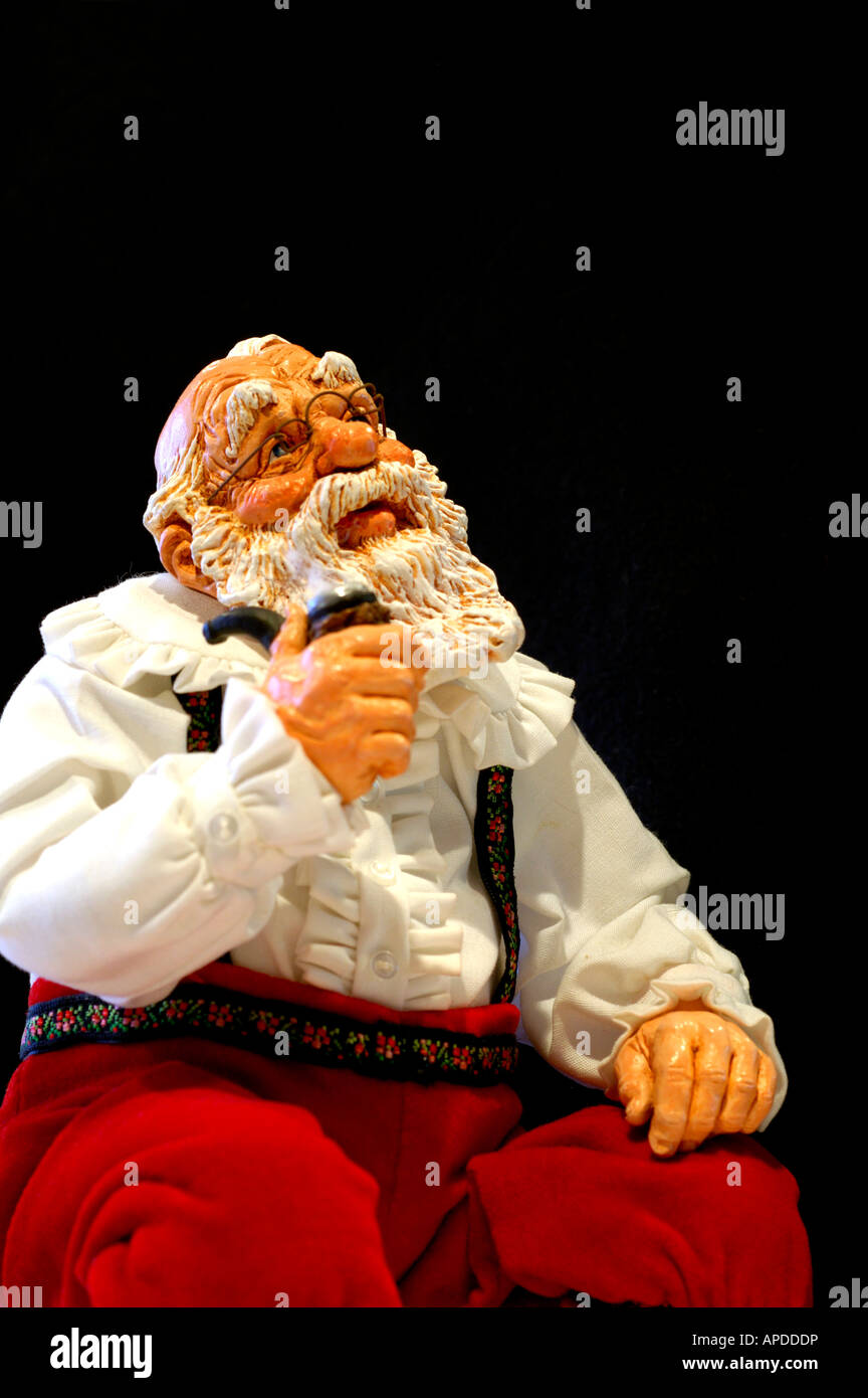 Holiday still life. Simpich Character doll, thinking Santa with pipe. Property released. Stock Photo